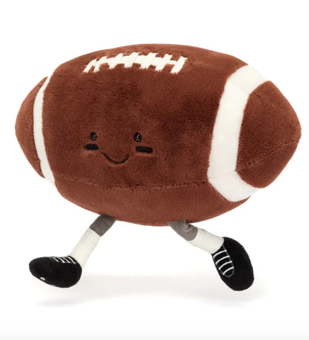 this is a cartoony stuffed football with legs black eyes and faceprint under the eyes.