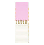A wired pocket notebook opens vertically to reveal white lined pages and a pastel pink front cover.