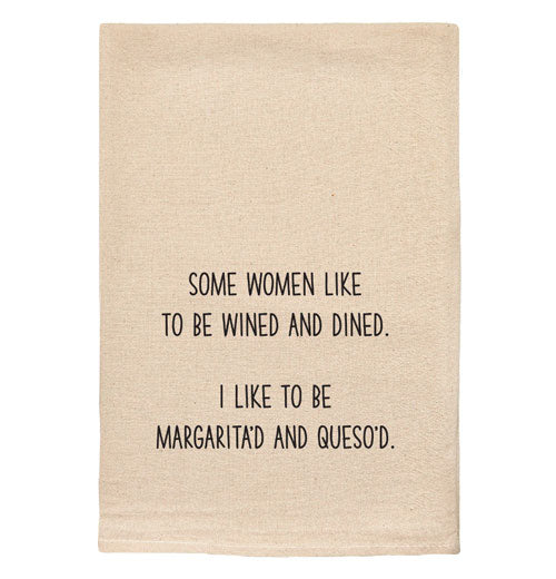 A beige tea towel with black text reading "Some women like to be wined and dined. I like to be margarita&