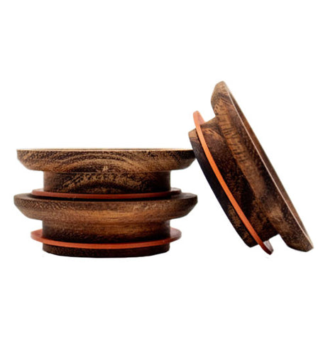 A stack of two wooden lids. Another lid is leaning against the stack.