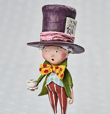 This mad hatter figurine of Alice in Wonderland is wearing red pants with white stripes, a blue vest with a green coat, a yellow bow tie with red dots and a purple oversized top hat with pink hatband. .