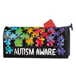 Metal mailbox wrap cover with rainbow colored puzzle pieces all over it to represent Autism Awareness.