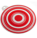 A white and red jar opener is textured and shaped like a circle, with a hole that sticks out for hanging.