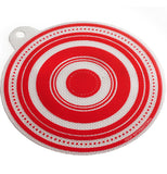 A white and red jar opener is textured and shaped like a circle, with a hole that sticks out for hanging.