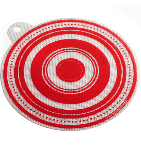 A white and red jar opener is textured and shaped like a circle, with a hole that sticks out for hanging.