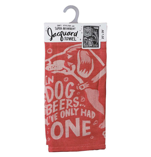 This red dish towel hanging from a gray hook has a white image of a dog on it with the words, "In Dog Beers I&