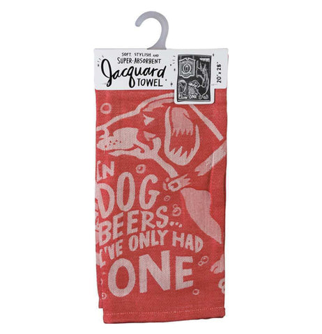 This red dish towel hanging from a gray hook has a white image of a dog on it with the words, "In Dog Beers I've Only Had One" in white lettering.
