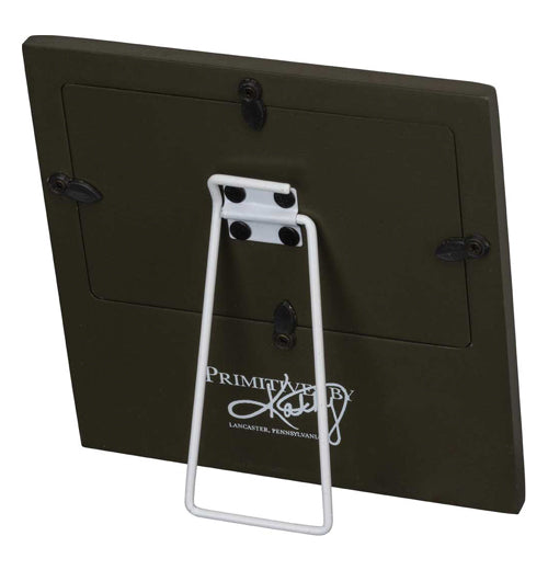 The back of the picture frame is shown with a white stand and the logo, "Primitives by Kathy" in white lettering at the bottom.