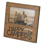 This picture of a family standing on a platform overlooking the coastline is surrounded by a brown wooden frame with the words, "Happy Campers" in black lettering at the bottom. A picture of an RV is shown next to the word "Happy" .