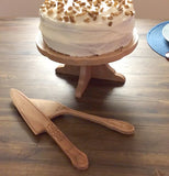 A beechwood edged cake plate with a cake sitting on top.