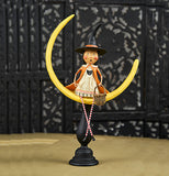 The "Moonlight Magic" figurine sits on the wooden table. 