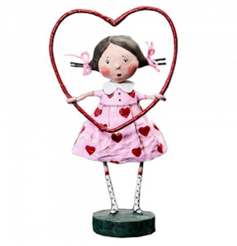 The Framed with Love figurine shows a girl with a pink dress with red hearts holding a red heart hula hoop. 