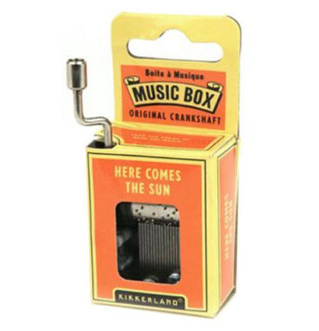 Here comes the sun music box is displayed in it's yellow and orange box.