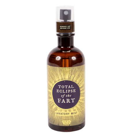 The Eclipse of the Fart Lavatory Mist mist comes in a brown bottle with a gold label with an eclipsed son design and text that reads "Total Eclipse of the Fart"
