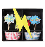 The black package of the "Super Hero" Cupcake Kit has a yellow lightning bolt and shows cupcake wrappers and the toppers. 