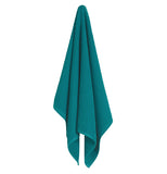 Teal ripple patterned dish towel hung up ready to be used.