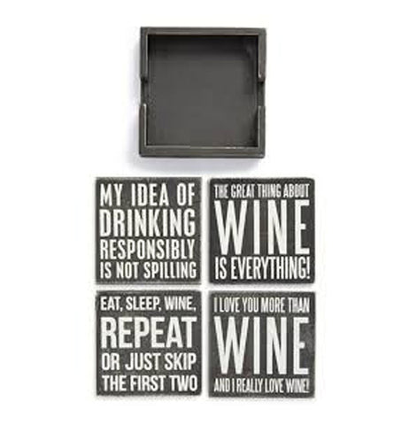 At the top of this picture is the wooden holder, which is empty. Below the holder are four black wooden coasters. The first one reads in white lettering, "My Idea of Drinking Responsibly is Not Spilling", while the second coaster reads in white lettering, "The Great Thing About Wine is Everything". The Third coaster reads, "Eat, Sleep, Wine, Repeat, or Just Skip the First Two", and the fourth coaster reads, "I Love You More Than Wine and I Really Love Wine".