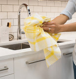 This bright yellow and white plaid lemon dishtowel that someone is using in the kitchen.
