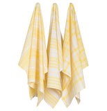 Three jumbo dishtowels that have a  yellow and white  patterns hanging up on a wall two having a striped pattern and one having a plaid pattern.