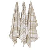 Set of three Sandstone brown and white jumbo dish towels with a two of them having a striped pattern and a third with a plaid pattern that are hung up on a wall.