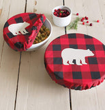 The set of 2 red plaid "Buffalo Check Bear" bowl covers over two bowls on a white wooden table. 