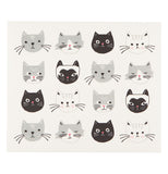 A gray drying mat with pictures of darker gray and black cat heads on a white background.
