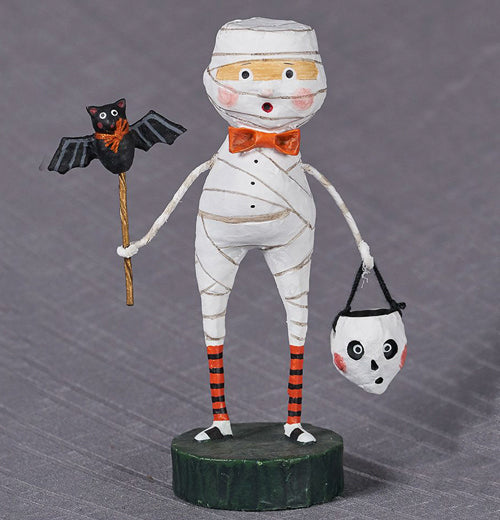 The Mummy Boy stands on a grayish background. 