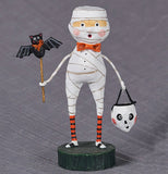 The Mummy Boy stands on a grayish background. 
