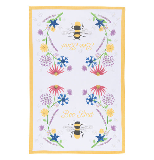 This white tea towel with a yellow rim surrounding its edges sports a design of bees and red, purple, yellow, and blue flowers and yellow text that reads "Bee Kind".