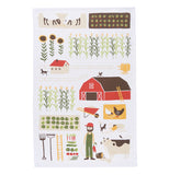 The towel that shows aspects of farming is shown by itself. It depicts crops, a barn, several cows, and a pig.