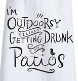 This close-up is of the white dish towel containing black text saying, "I'm Outdoorsy I Like Getting Drunk on Patios".