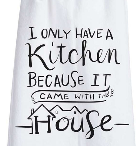 This close-up is of the white dish towel containing the black text saying, "I Only Have a Kitchen Because It Came With The House" on it.