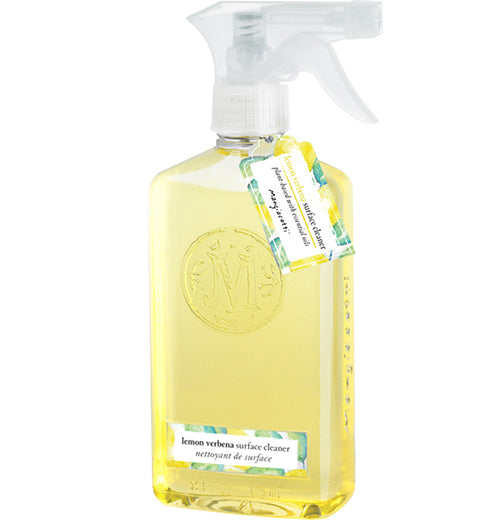 A clear bottle has yellow surface cleaner in it, a silver-colored and white plastic top, and a blue, yellow, and white label sticker and hangtag.
