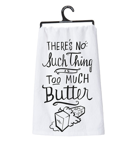 This is a white dish towel with the words, "There's No Such Thing As Too Much Butter" in black print. Below the words is a drawing of an opened stick of butter. Holding it is a black plastic hanger.