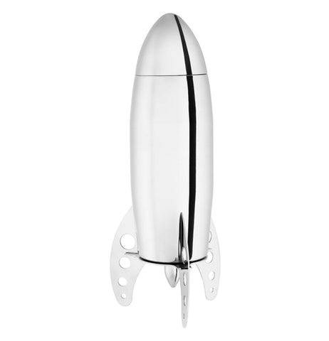 Side view of a silver metal rocket shaped Cocktail Shaker standing up on it's three legs with a white background