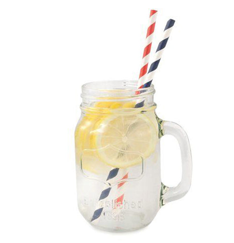 The orange and black striped straws are shown inside a drink filled with lemons.