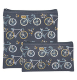 Two black cotton zippered pouches with images of 3 different styled bicycles. Two are light blue with white tires and the other is white with gold tires. The bags are stacked on top of each other and one bag is taller than the other.  