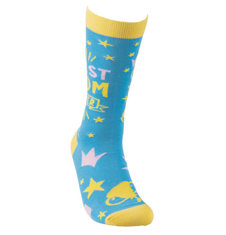 These sky blue socks have yellow tops, bottoms, and heels. Scattered across the blue background are yellow and pink drawings of stars and cups. In the middle of the sock near the top are the words, "Best Mom Ever" in pink and yellow lettering.