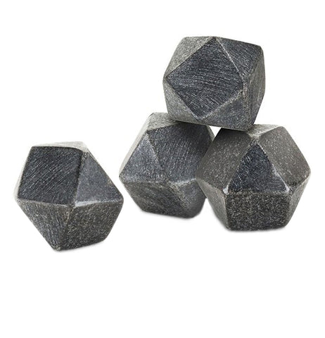 These are four black hexagonal ice cubes made to look like stones from a glacier.