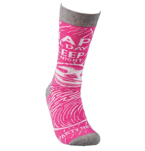 This pink sock with a gray top, heel, and toe sports a white stenciled image of a sloth. Above the sloth's head are the words, "Nap All Day Sleep All Night" in white lettering.