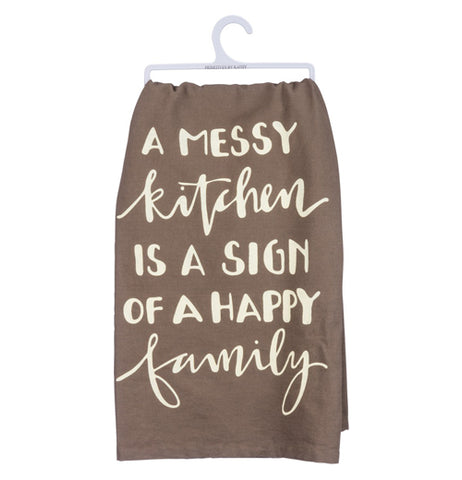 A brown dish towel hanging from a white hanger with the words "A Messy Kitchen is a sign of a happy family" written in tan.
