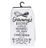 White dish towel that has the words "Grammy's Kitchen Where Memories are Made and Grandchildren are Spoiled" with baking tools and flowers all in black on a white background.