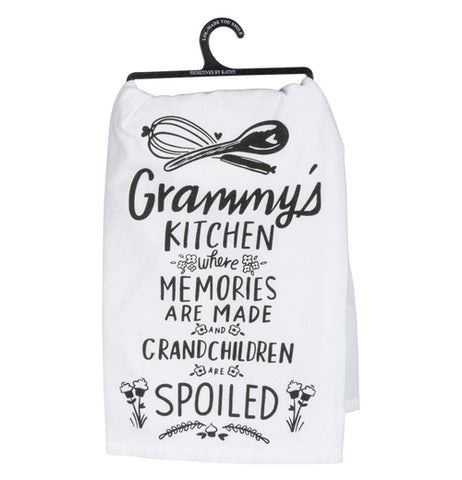 White dish towel that has the words "Grammy's Kitchen Where Memories are Made and Grandchildren are Spoiled" with baking tools and flowers all in black on a white background.
