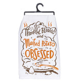White Mashed Potato dish towel with design of a platter of mashed potatoes with spoon and the words "Thankful Blessed and Mashed Potato Obsessed" in brown and orange above.