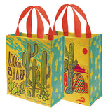 A yellow and blue desert themed tote featuring a variety of different cacti along with the phrase "Lookin' Sharp"
