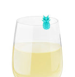 The teal drink charm is shown attached to a wine glass filled with white wine.
