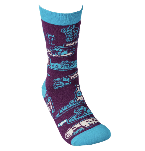 This picture shows one of the "Bring More Wine" socks being worn by one foot.