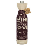 The "Pairs Well" bottle cover reads "This Wine Pairs well with Love" in white over a purple background on a bottle. 