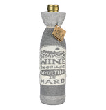 This is one side of the cover showing the white sign with the words, "Wine Because Adulting is Hard" in gray lettering.