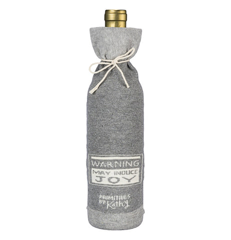 This is the other side of the gray bottle cover with the white sign reading, "Warning: May Induce Joy." in gray lettering, and below the sign is the logo, "Primitives by Kathy".